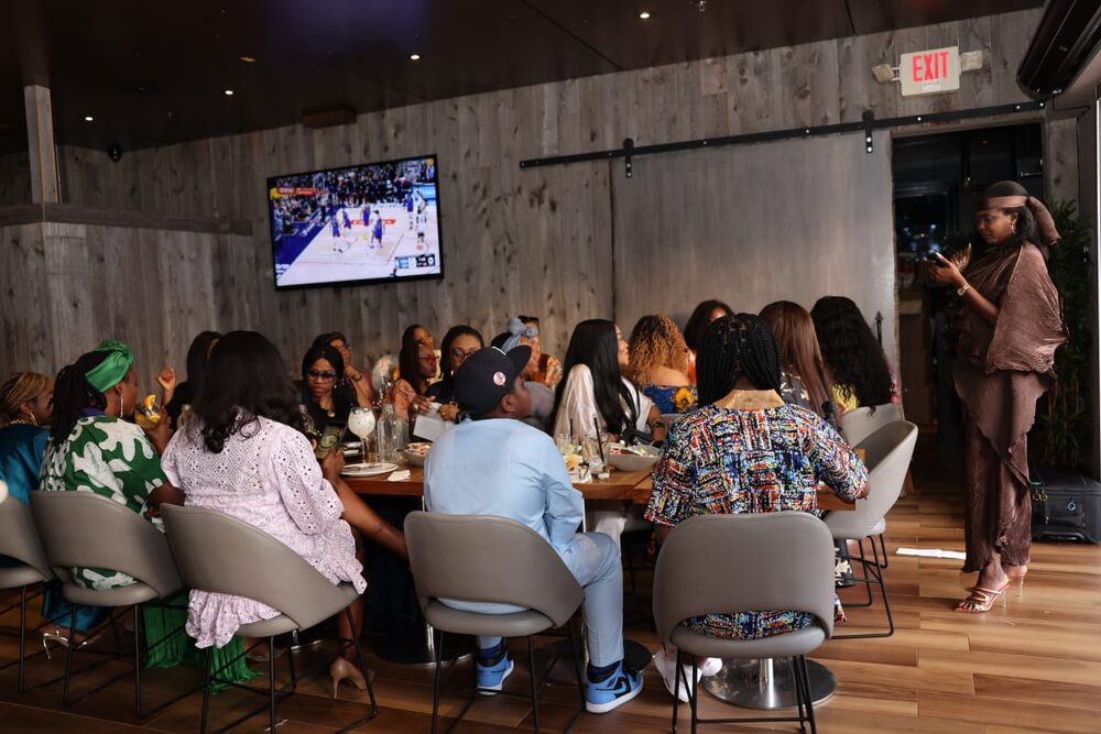An elegant hosted event with guests seated at a long dining table