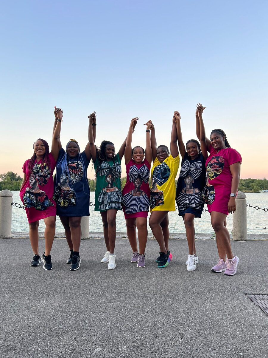 Group of women celebrating together at sunset by the lake